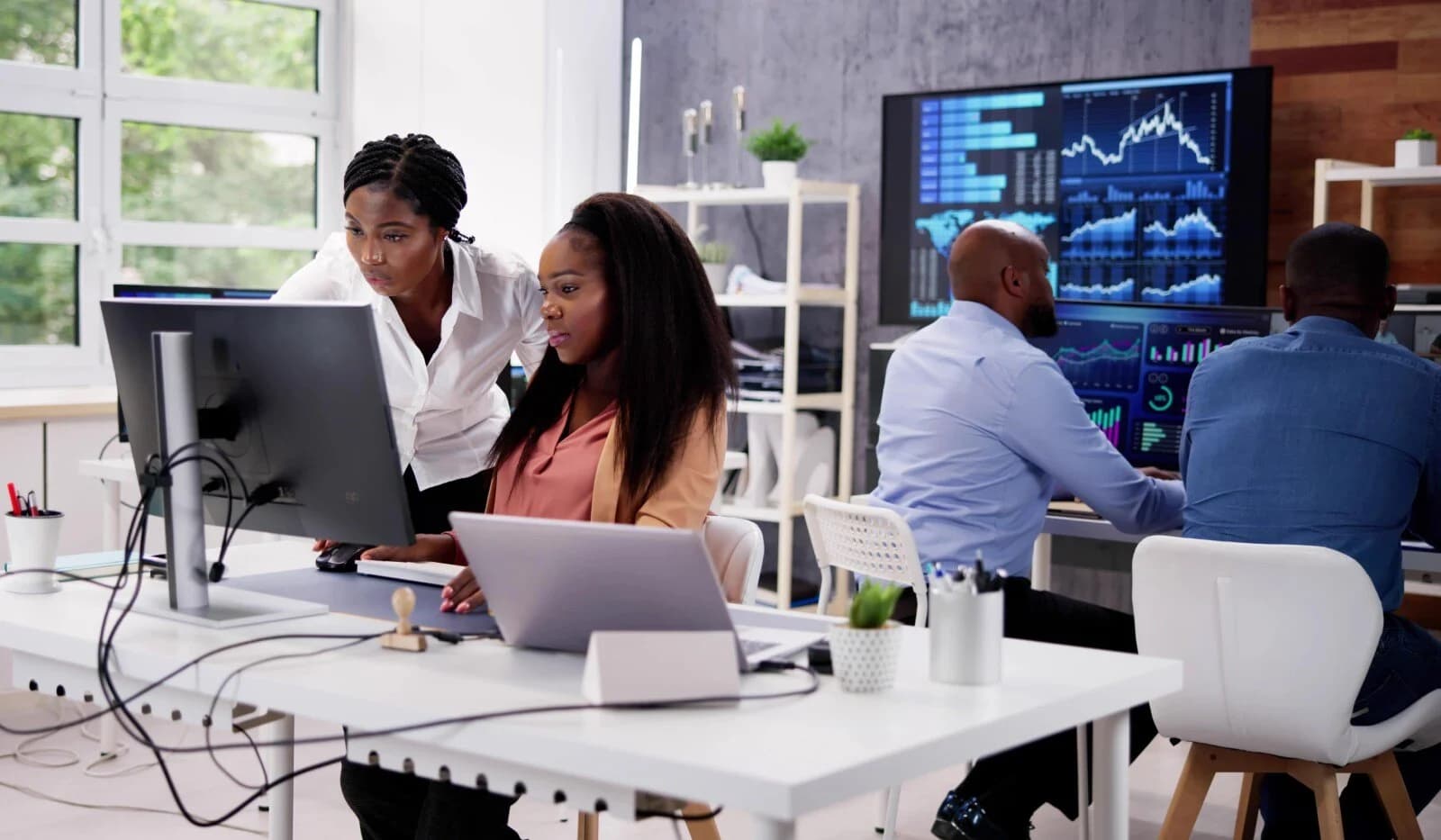 Black business professionals working on data analytics and industry metrics in a Lagos office